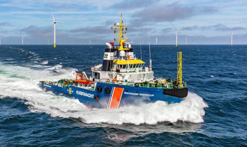 De noodhulpsleper van de Kustwacht, Multraship Protector ligt op zee paraat in de buurt van de windparken Hollandse Kust